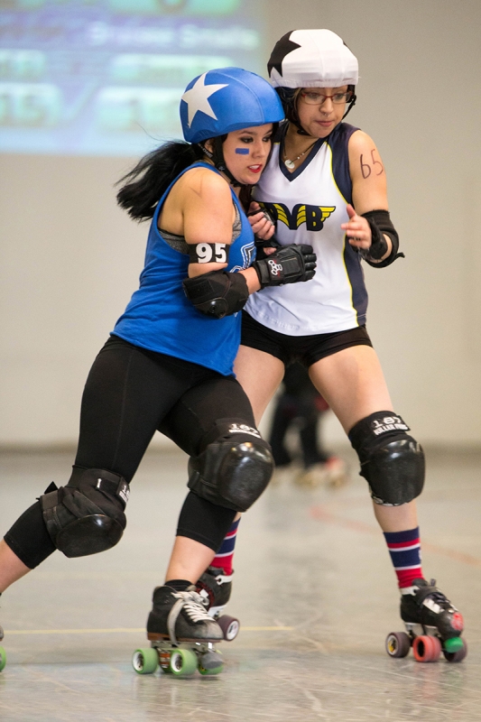 (L–R): Animal Krackher and Bruisee Smalls fight for position and points at the Wasatch Roller Derby. The Portneuf Bruisers visited the Wasatch Bonebille Bone Crushers on April 11, 2015. 